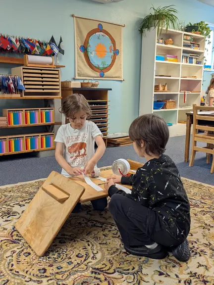 Children working together with Montessori materials